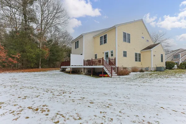 a view of a house with backyard and trees