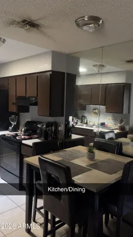 a kitchen with a table and chairs in it