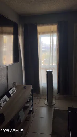 a view of a room with a table wooden floor and a cabinet