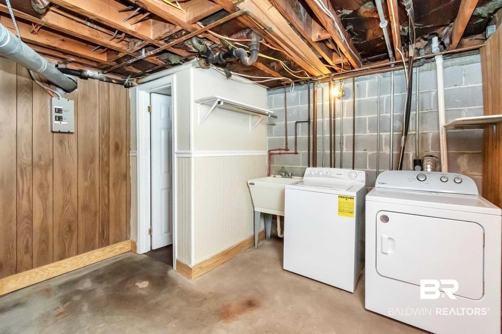 308 Brawood Drive Mobile, AL 36608 - Photo 21 of 33 Basement featuring washing machine and dryer, sink, and wooden walls
