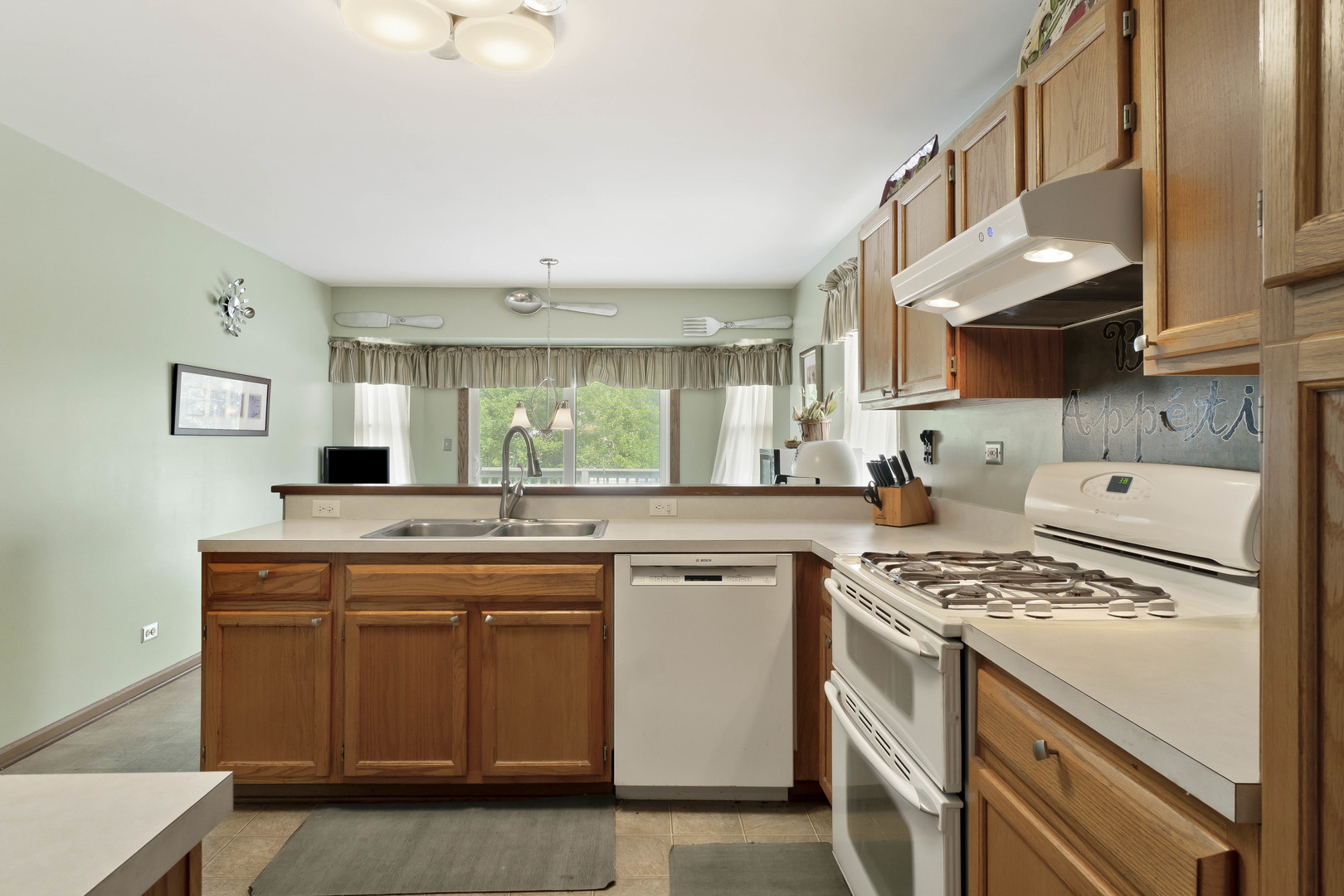 374 Fox Bend Circle Bolingbrook, IL 60440 - Photo 7 of 32 a kitchen with kitchen island granite countertop a sink stove and cabinets
