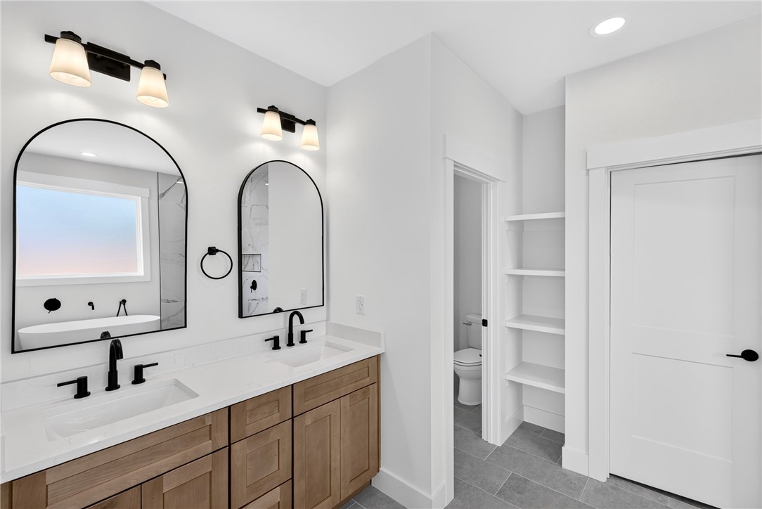 416 Blume Road Anderson, SC 29625 - Photo 21 of 29 Dual vanities with modern fixtures elevate this primary bathroom's clean-lined aesthetic.