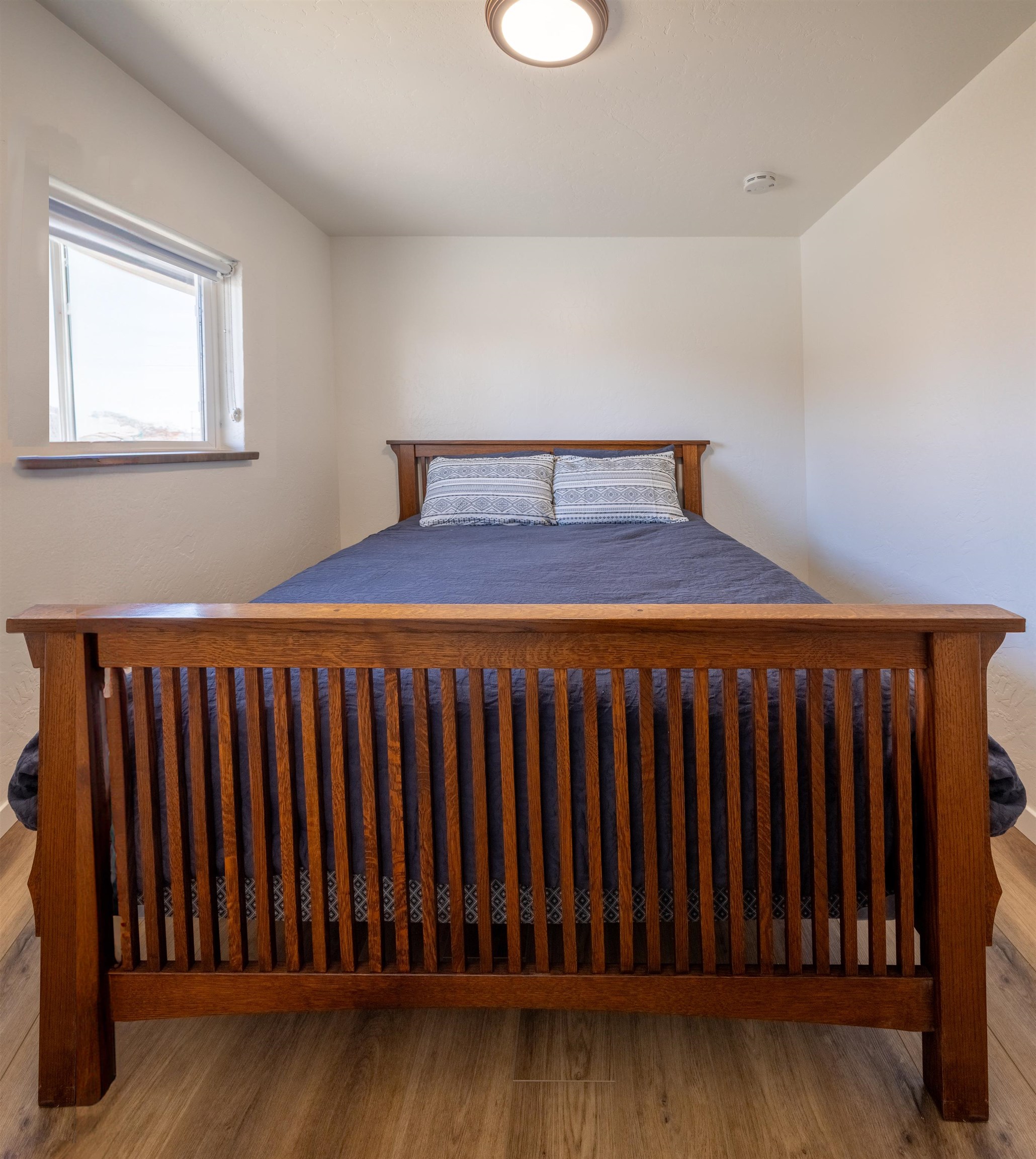 137 North Willow Street Fruita, CO 81521 - Photo 13 of 27 a bedroom with a bed and wooden floor