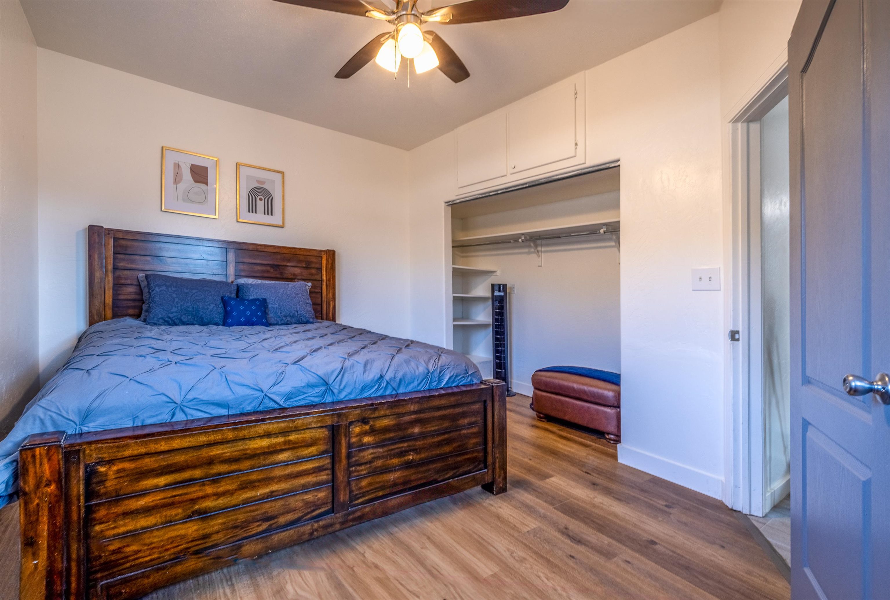 137 North Willow Street Fruita, CO 81521 - Photo 18 of 27 a bedroom with a bed and a chandelier