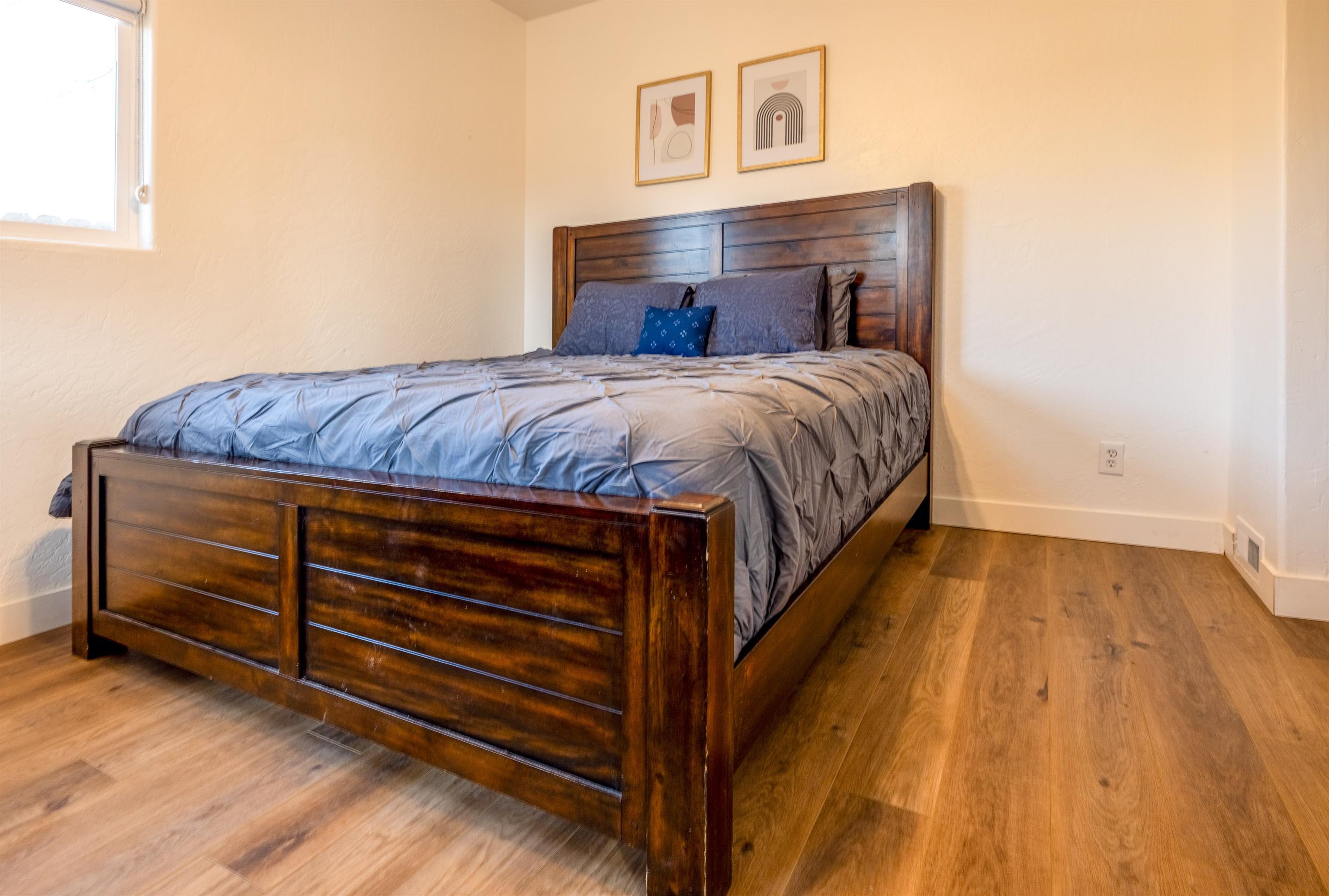 137 North Willow Street Fruita, CO 81521 - Photo 19 of 27 a bed sitting in a bedroom next to a wooden floor