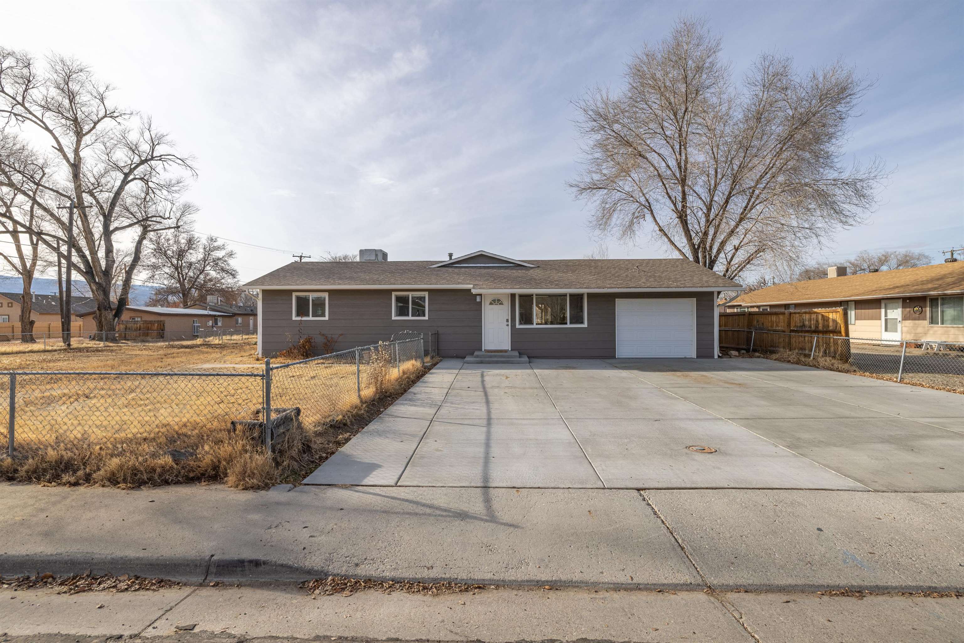 137 North Willow Street Fruita, CO 81521 - Photo 2 of 27 a front view of a house with a yard and garage
