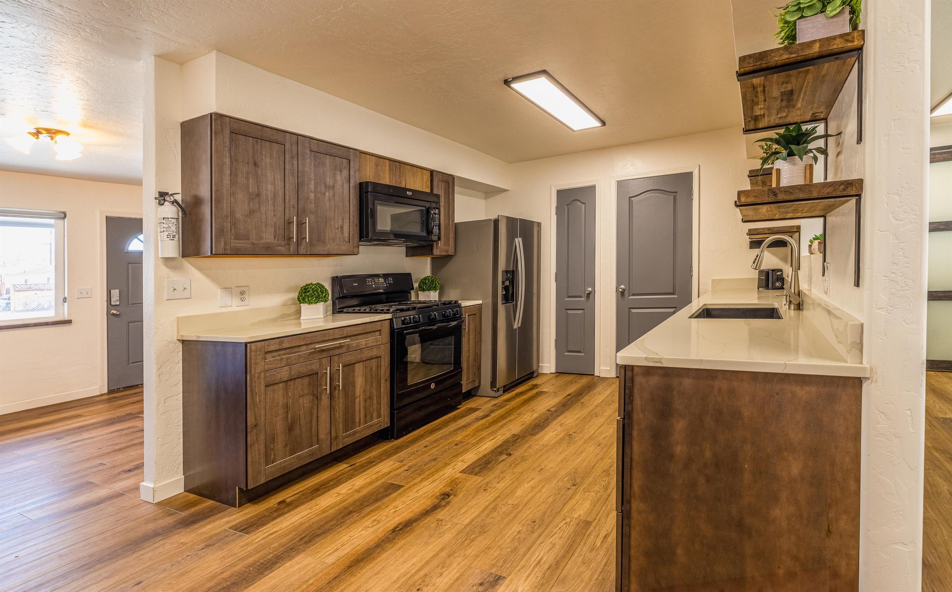137 North Willow Street Fruita, CO 81521 - Photo 5 of 27 a kitchen with stainless steel appliances a refrigerator and a stove top oven