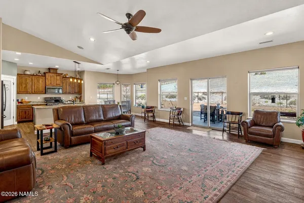 a spacious bedroom with a bed and a ceiling fan