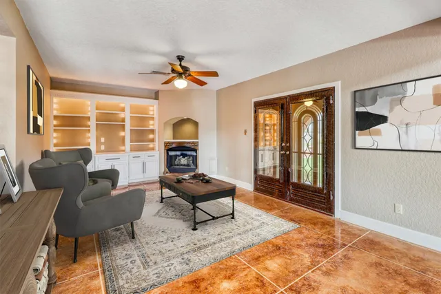 a living room with furniture a rug and a large window