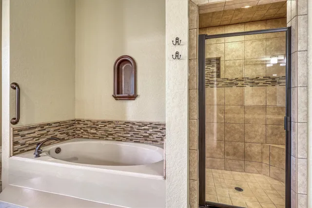 a bathroom with a bathtub and shower