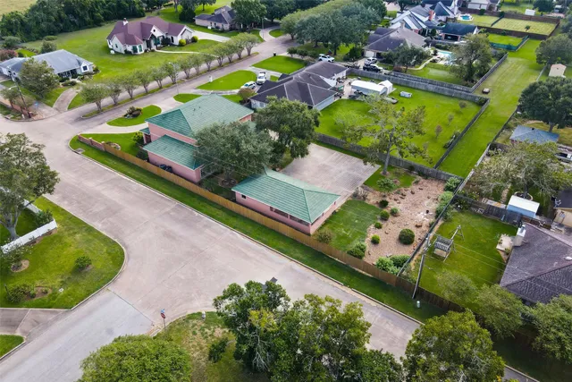 an aerial view of a residential houses with outdoor space
