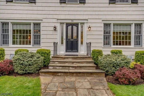 a view of a house with potted plants