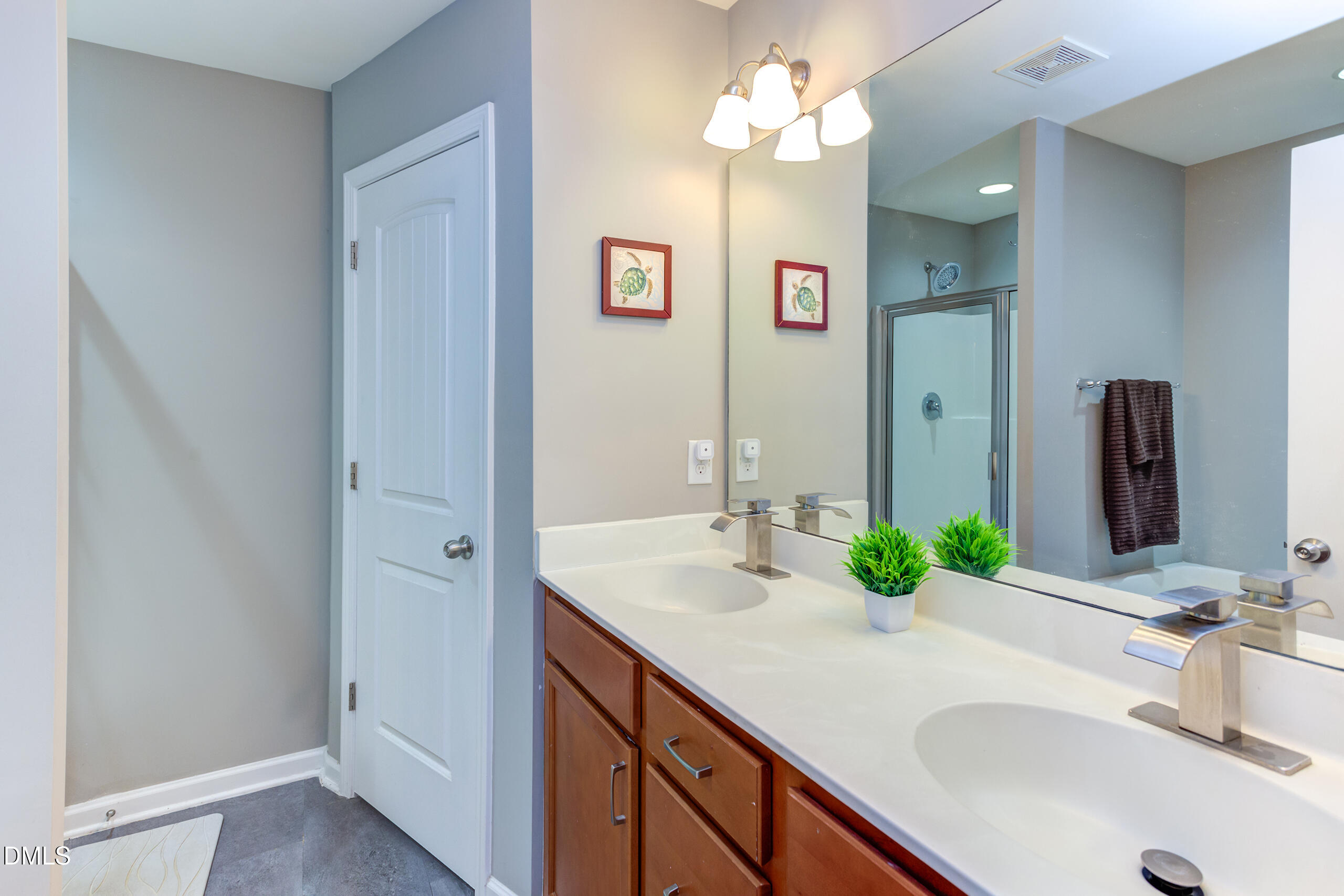 1434 Chatuga Way Wake Forest, NC 27587 - Photo 19 of 29 a bathroom with a sink vanity and a mirror