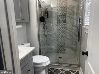 a bathroom with a shower and a toilet