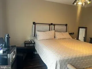 a bedroom with a bed and a night stand