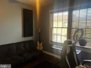 a living room with furniture and floor to ceiling window