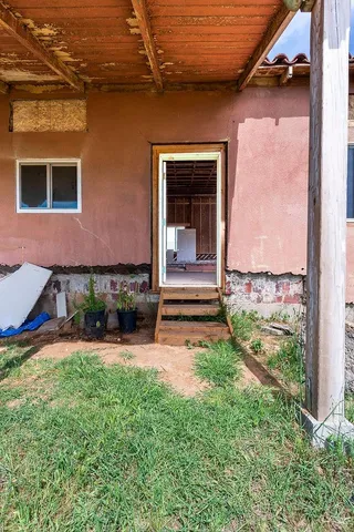 a backyard of a house with barbeque oven and outdoor seating