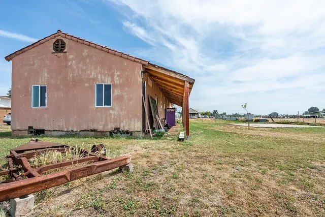 a backyard of a house with wooden floor and fence