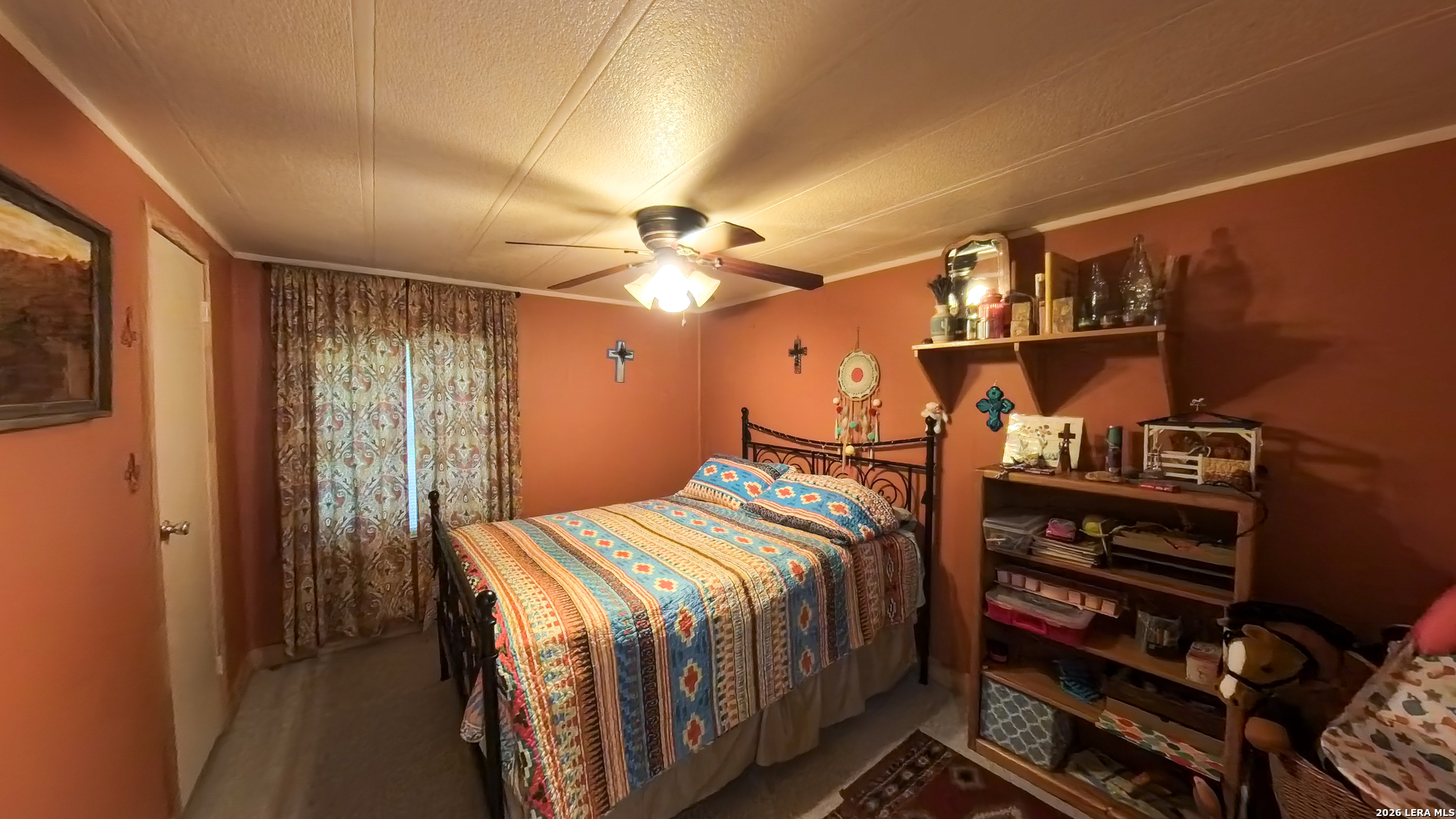 857 Madrona Road Pipe Creek, TX 78063 - Photo 16 of 49 a bedroom with a bed and a chandelier