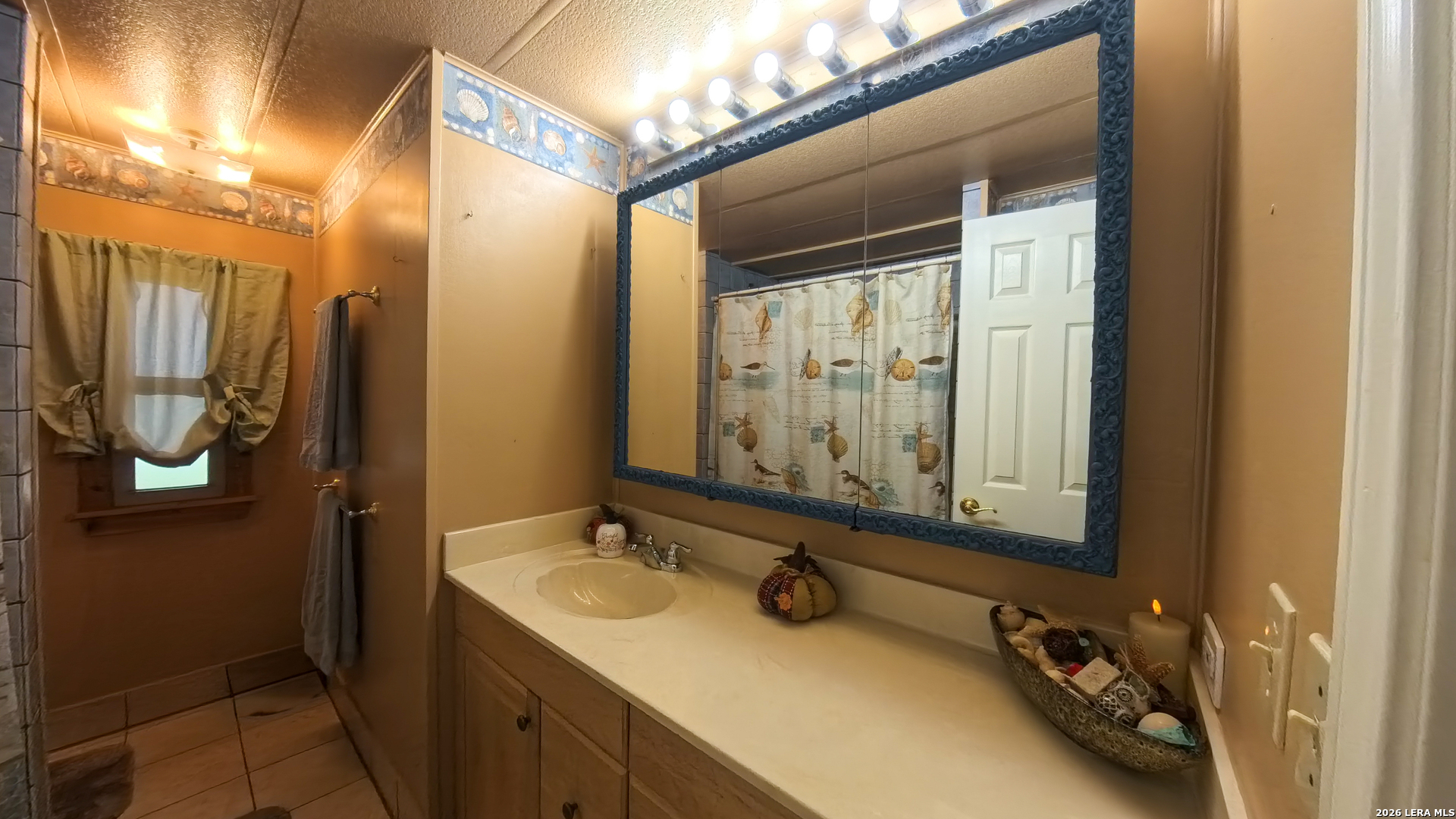 857 Madrona Road Pipe Creek, TX 78063 - Photo 17 of 49 a bathroom with a sink double vanity and a mirror