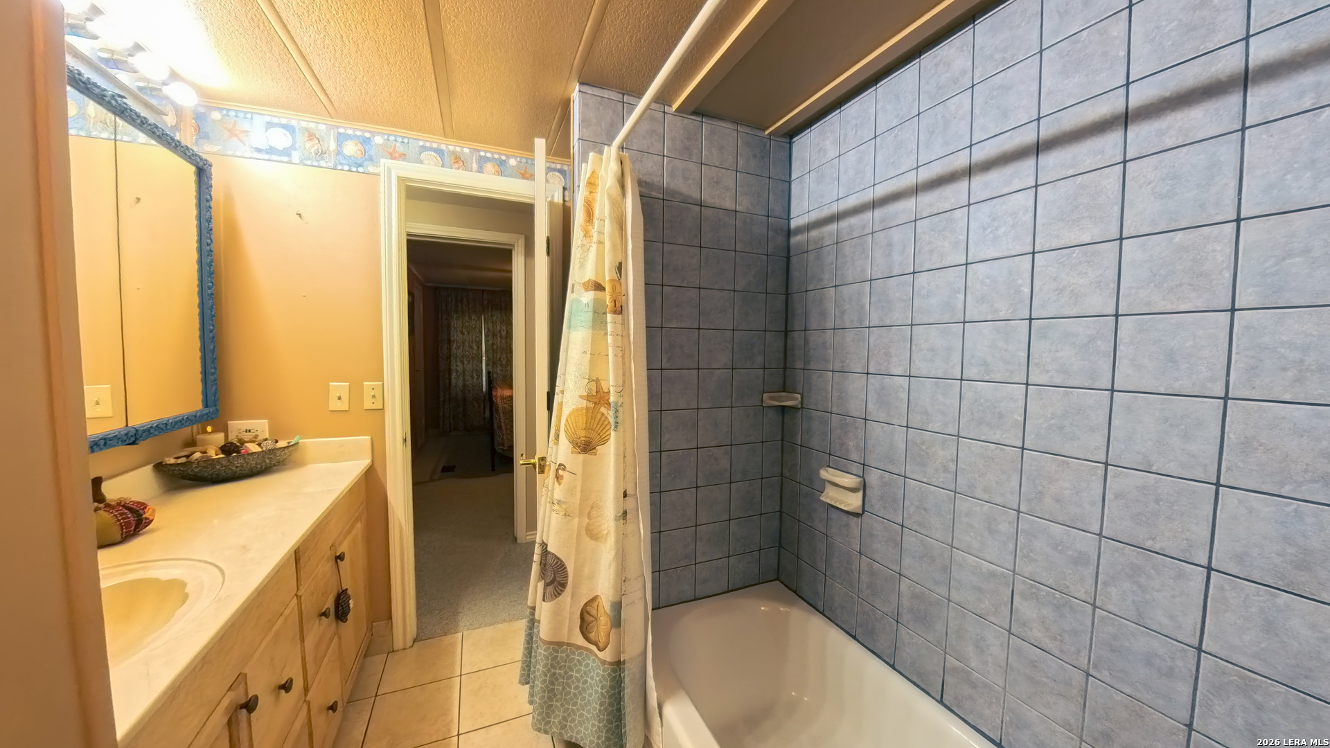 857 Madrona Road Pipe Creek, TX 78063 - Photo 18 of 49 a bathroom with a granite countertop sink a toilet and shower