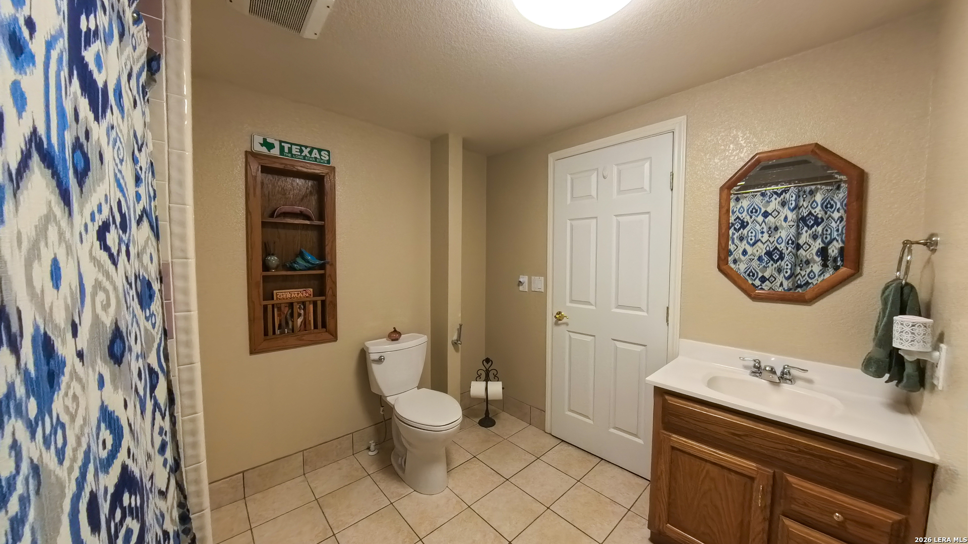 857 Madrona Road Pipe Creek, TX 78063 - Photo 20 of 49 a bathroom with a sink a toilet and a shower