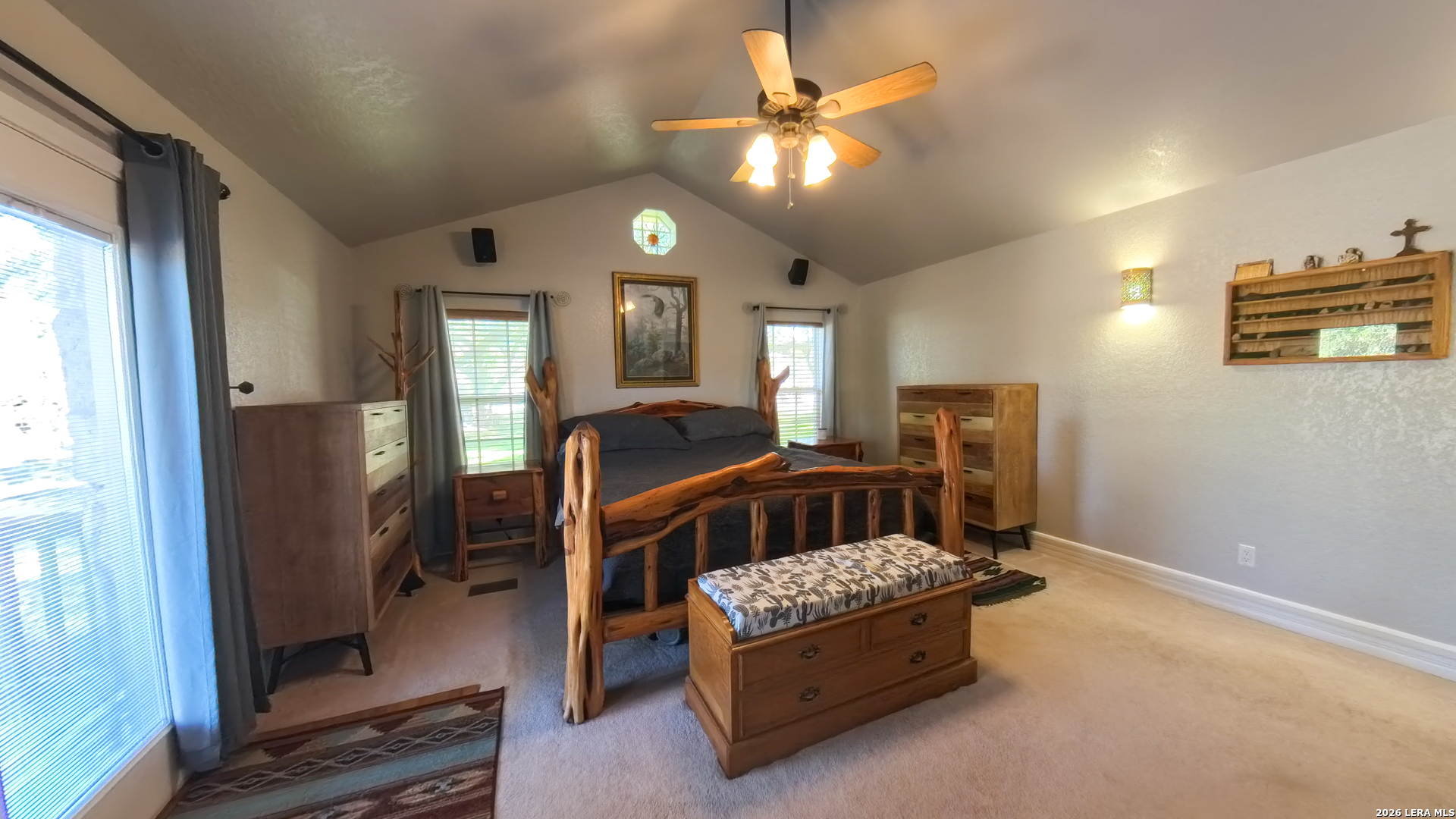 857 Madrona Road Pipe Creek, TX 78063 - Photo 22 of 49 a bedroom with a bed next to a window with the dresser