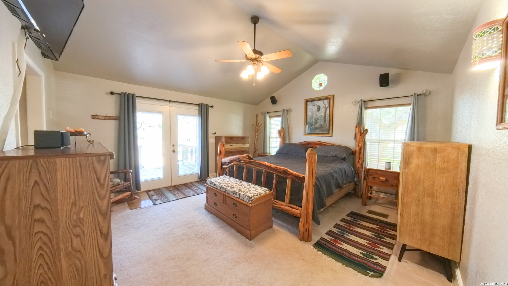 857 Madrona Road Pipe Creek, TX 78063 - Photo 23 of 49 a spacious bedroom with a bed window and couch