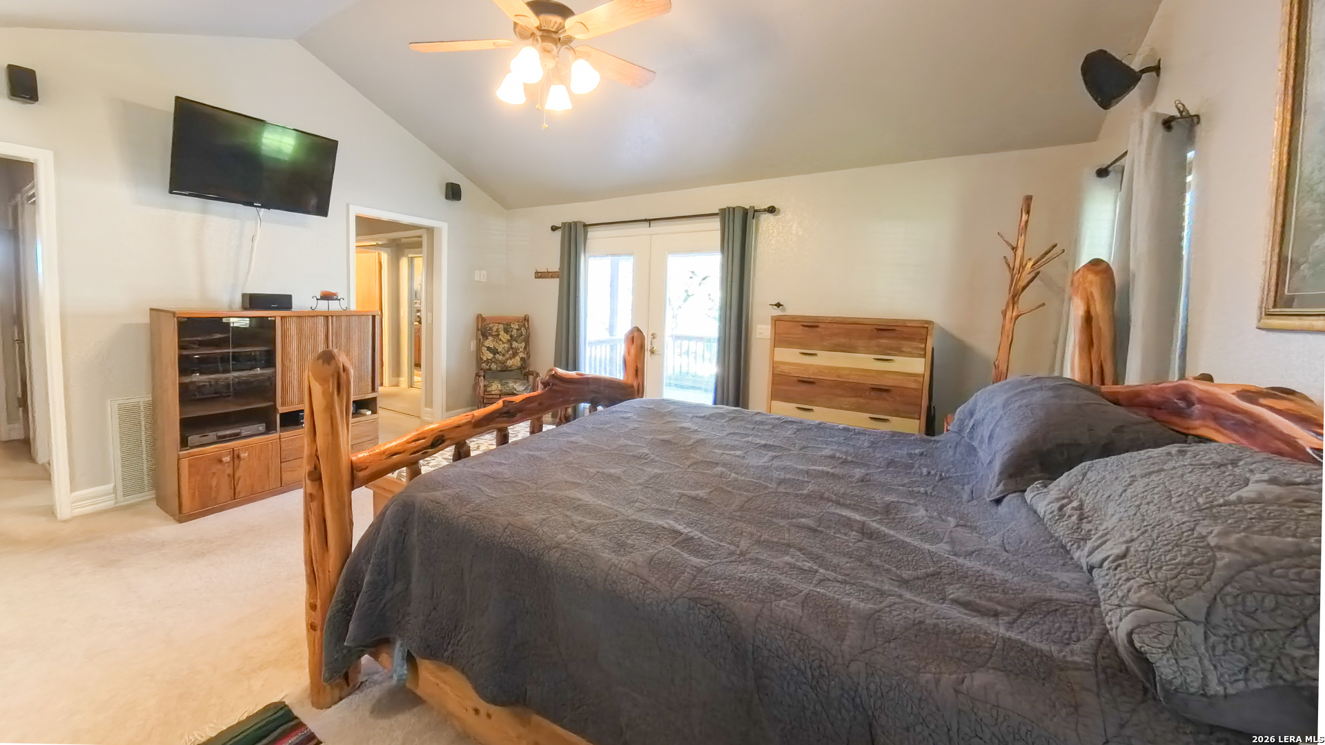 857 Madrona Road Pipe Creek, TX 78063 - Photo 24 of 49 a bedroom with a bed and a flat screen tv