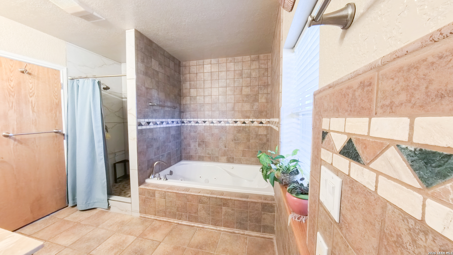 857 Madrona Road Pipe Creek, TX 78063 - Photo 28 of 49 a bathroom with a tub and shower