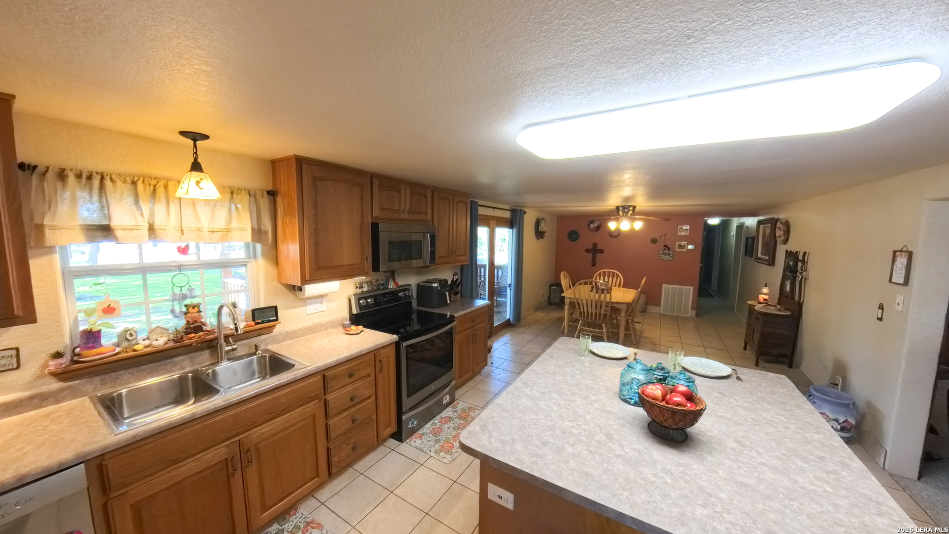 857 Madrona Road Pipe Creek, TX 78063 - Photo 6 of 49 a kitchen filled with a sink appliances and a counter top space