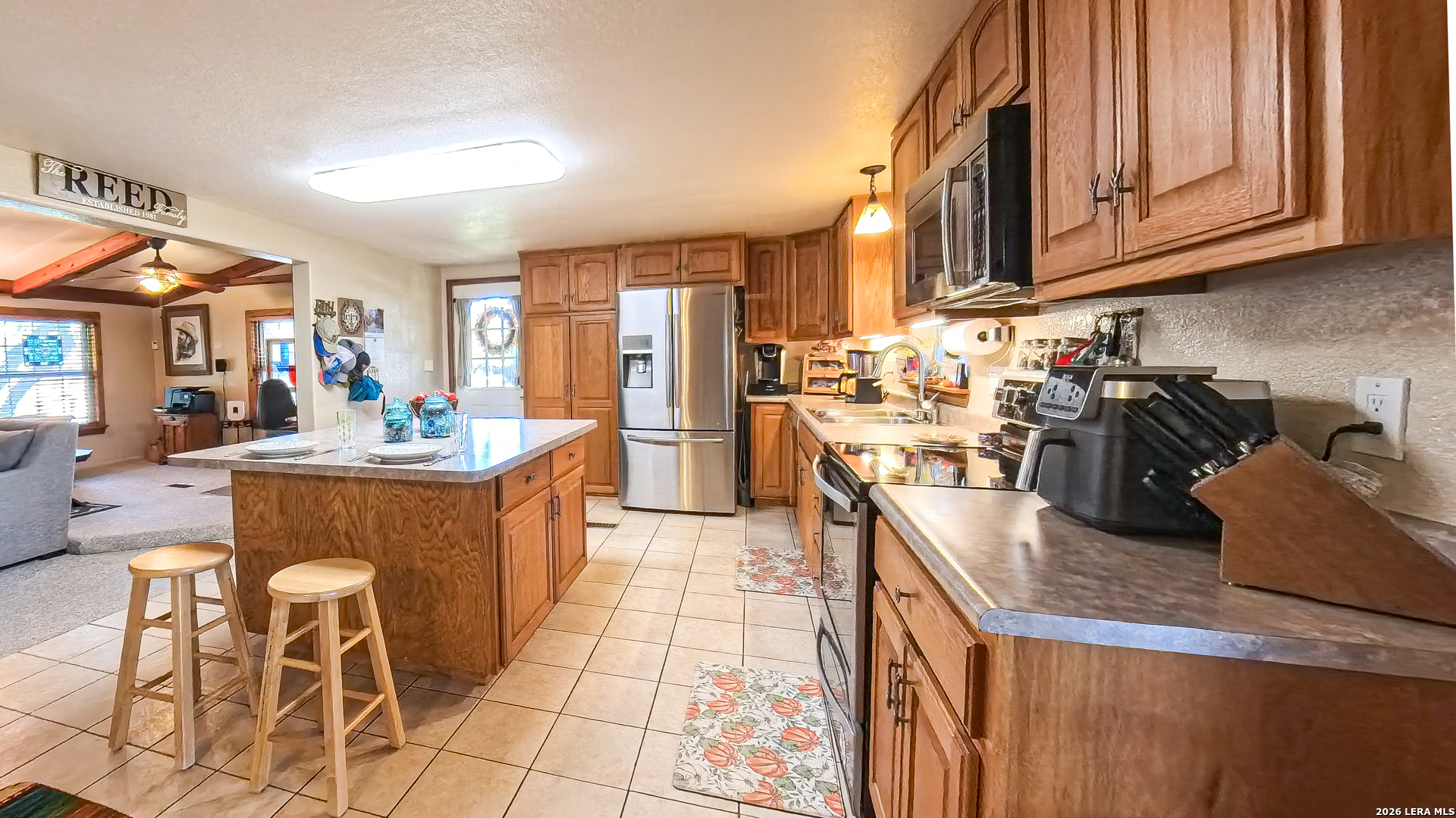 857 Madrona Road Pipe Creek, TX 78063 - Photo 7 of 49 a kitchen with stainless steel appliances granite countertop a sink a stove counter space and cabinets
