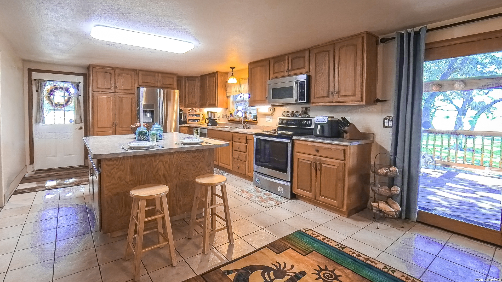 857 Madrona Road Pipe Creek, TX 78063 - Photo 8 of 49 a kitchen with stainless steel appliances granite countertop a stove top oven a sink dishwasher and cabinets