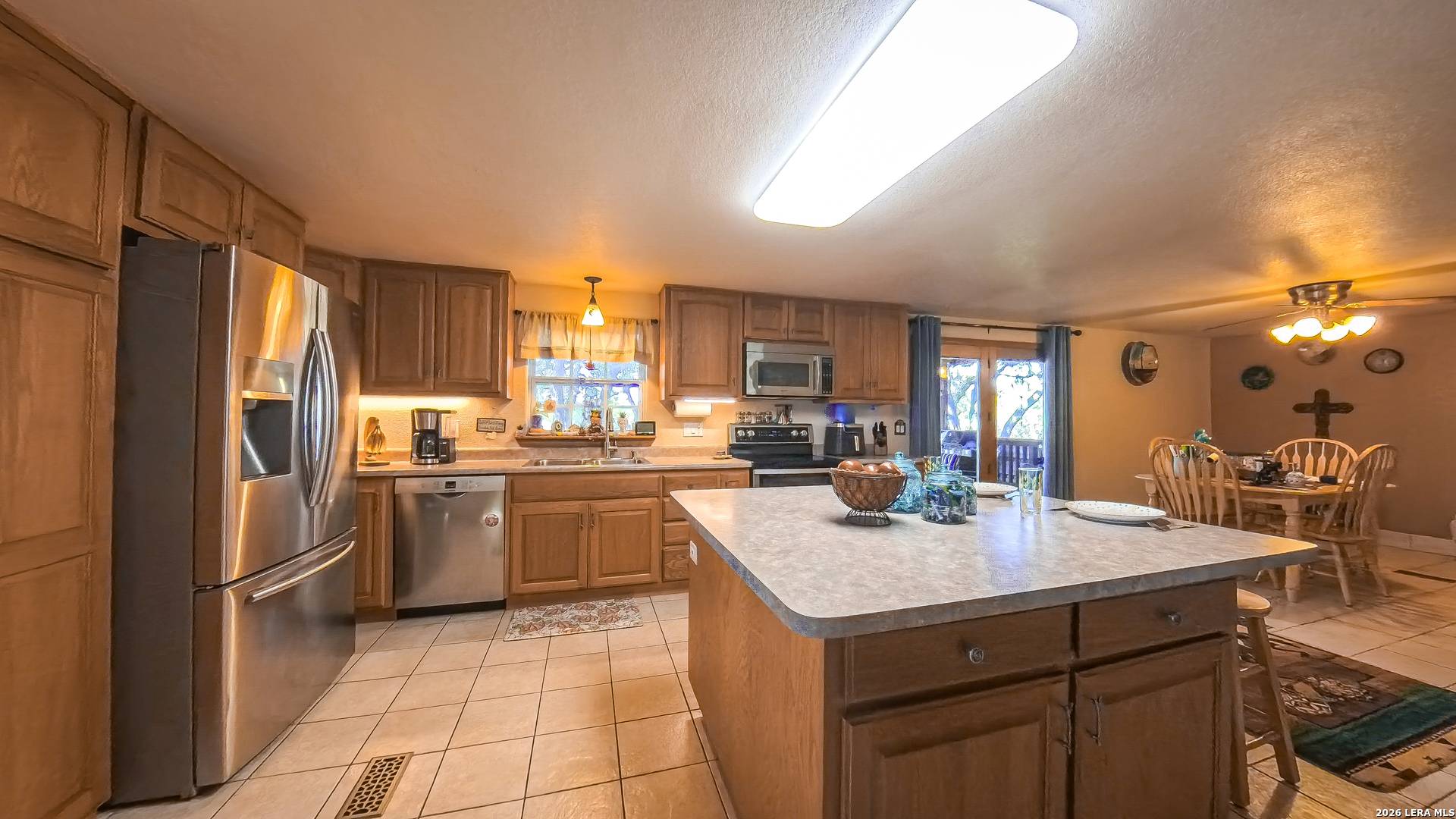 857 Madrona Road Pipe Creek, TX 78063 - Photo 9 of 49 a kitchen with a sink a counter top space and stainless steel appliances