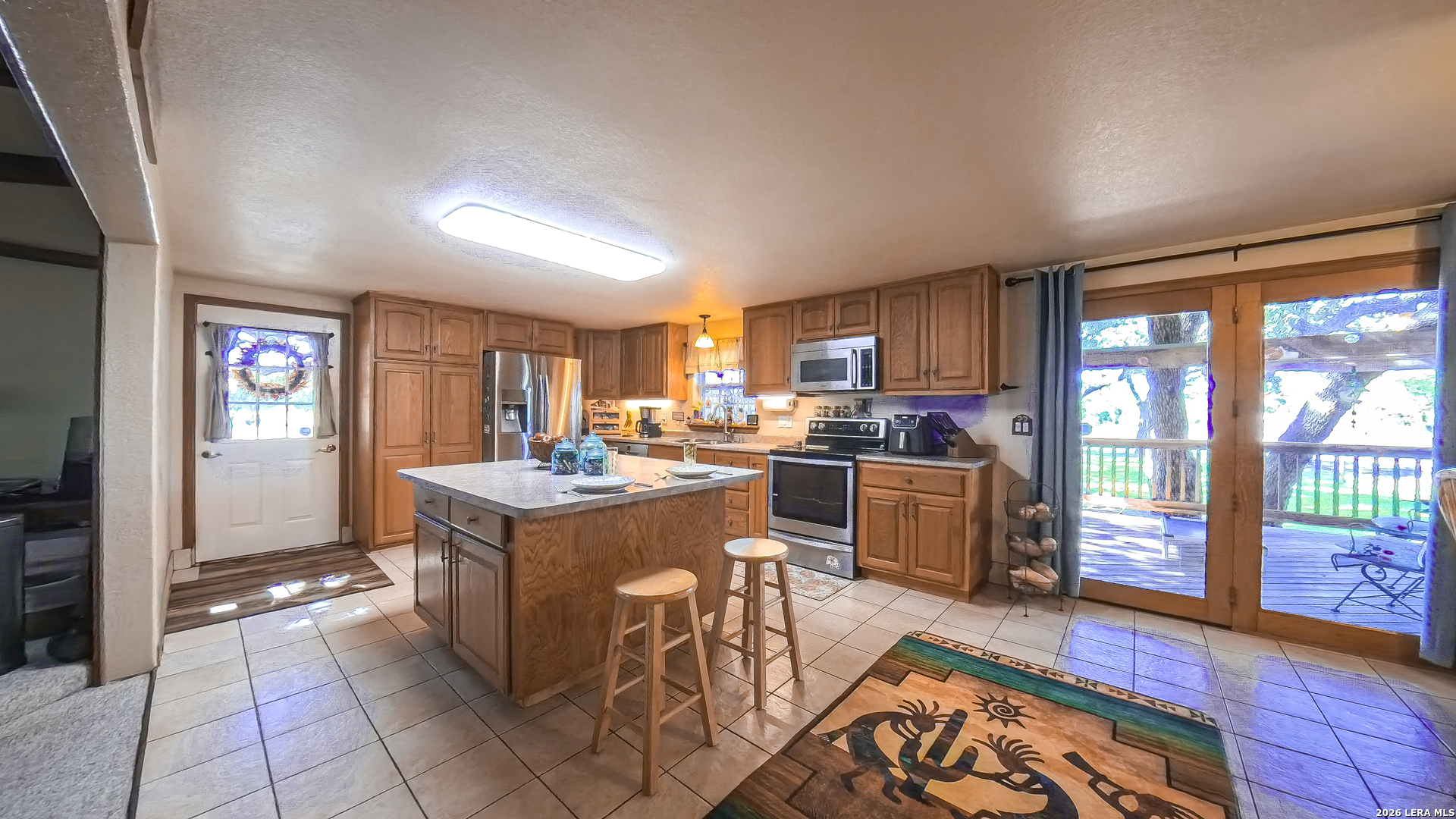 857 Madrona Road Pipe Creek, TX 78063 - Photo 10 of 49 a kitchen with a stove a refrigerator and furniture