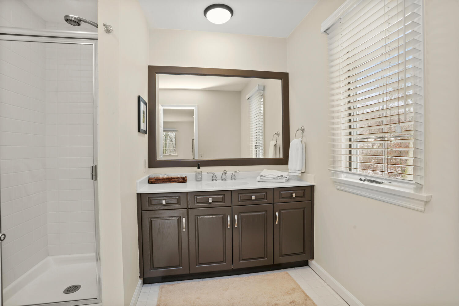 215 Marvin Ridge Road New Canaan, CT 06840 - Photo 24 of 31 a bathroom with a sink a mirror and a bathtub