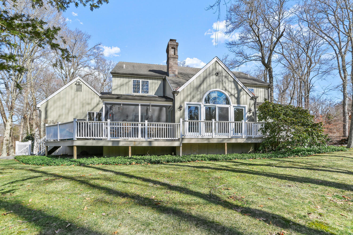 215 Marvin Ridge Road New Canaan, CT 06840 - Photo 26 of 31 a front view of a house with a garden and trees
