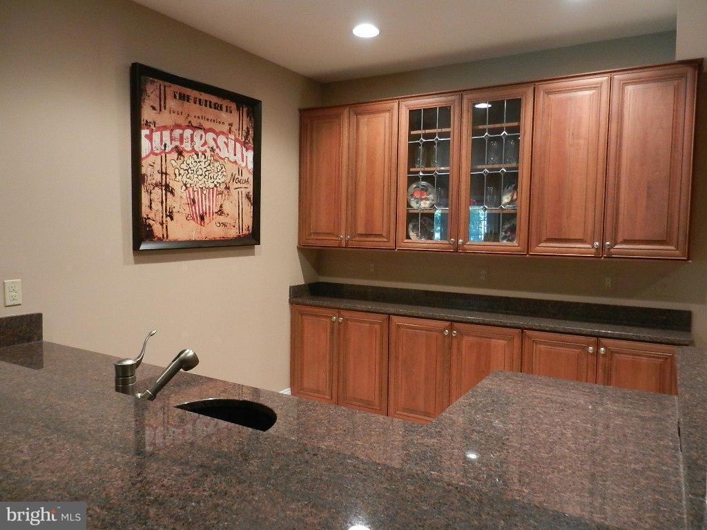 22526 Evergreen Mills Road Ashburn, VA 20148 - Photo 22 of 30 a kitchen with stainless steel appliances granite countertop a stove and a sink