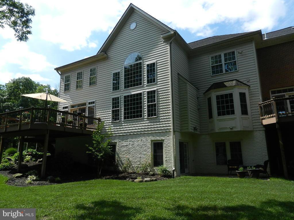 22526 Evergreen Mills Road Ashburn, VA 20148 - Photo 26 of 30 a front view of house with yard and green space