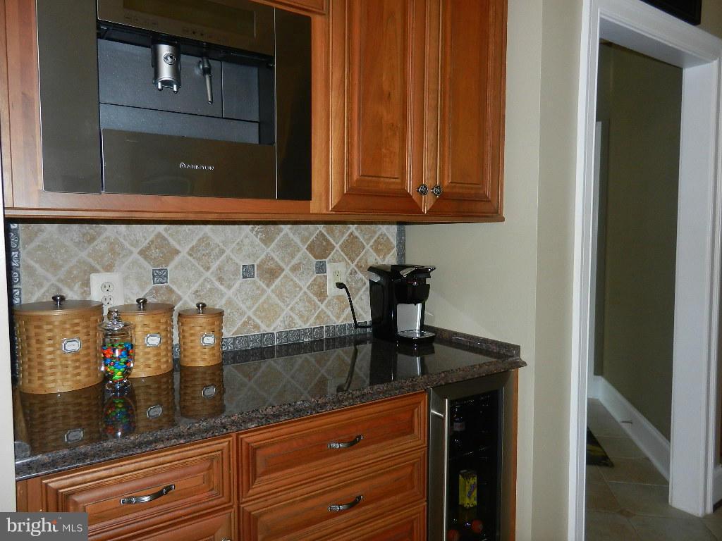 22526 Evergreen Mills Road Ashburn, VA 20148 - Photo 7 of 30 a kitchen with granite countertop white cabinets and a sink