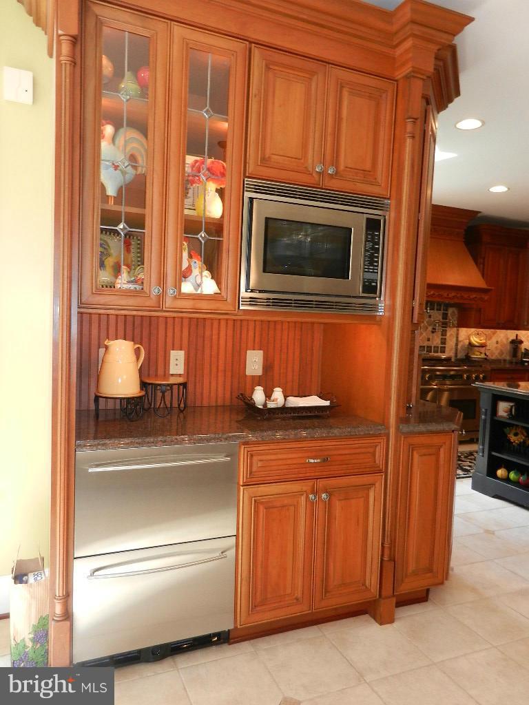 22526 Evergreen Mills Road Ashburn, VA 20148 - Photo 8 of 30 a kitchen with stainless steel appliances granite countertop a refrigerator and cabinets
