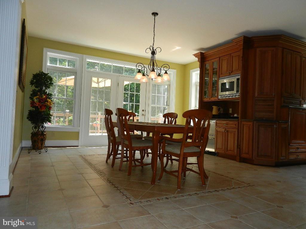 22526 Evergreen Mills Road Ashburn, VA 20148 - Photo 9 of 30 a dining room with furniture a window and kitchen view
