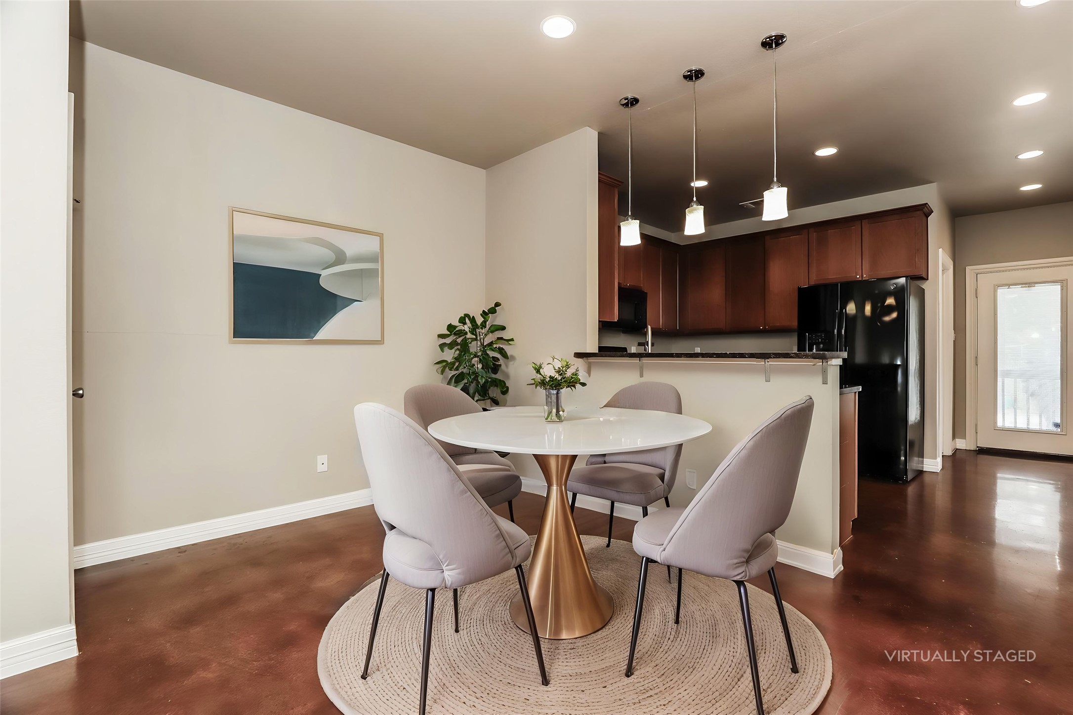 1701 Sanchez Street, Unit A Austin, TX 78702 - Photo 3 of 19 An inviting dining area with sleek pendant lights overlooks a well-appointed kitchen.