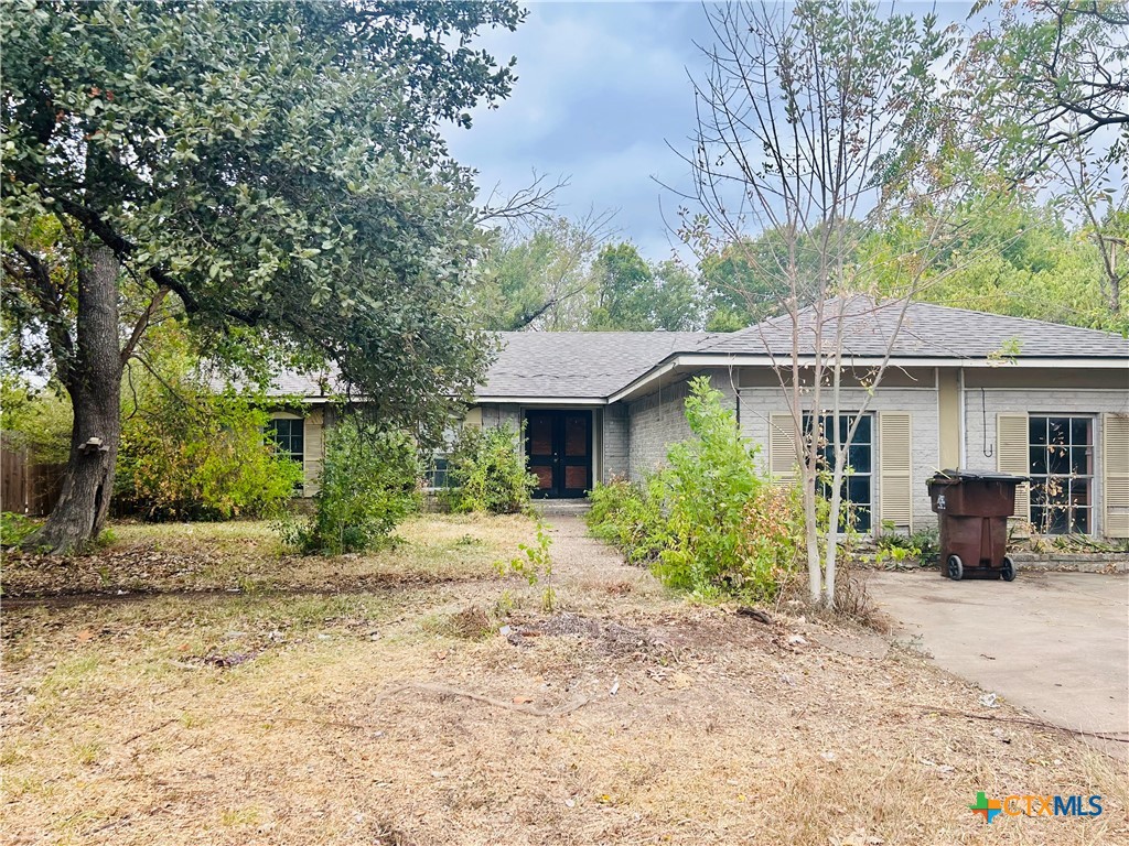 1406 Georgetown Street Round Rock, TX 78664 - Photo 1 of 1 a front view of a house with a yard and potted plants