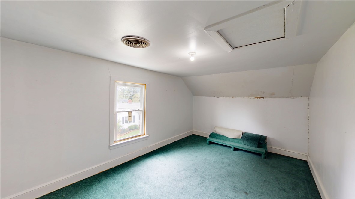 415 Church Street Pendleton, SC 29670 - Photo 27 of 35 A versatile attic space featuring a window and plush green carpet offers conversion potential.