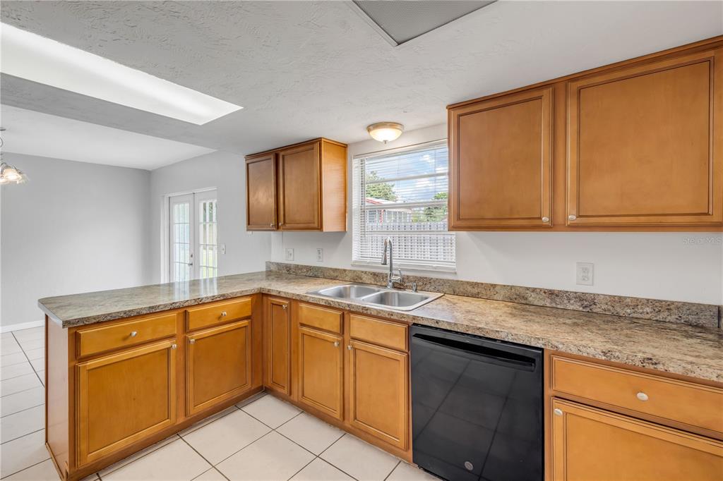 3132 Pine Tree Drive Edgewater, FL 32141 - Photo 14 of 32 a kitchen with a sink and cabinets
