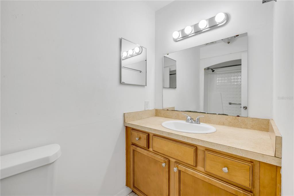 3132 Pine Tree Drive Edgewater, FL 32141 - Photo 20 of 32 a bathroom with a sink and a mirror