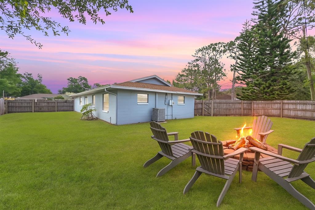 3132 Pine Tree Drive Edgewater, FL 32141 - Photo 2 of 32 a view of house with backyard and outdoor seating