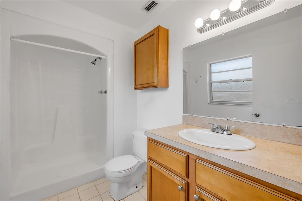 3132 Pine Tree Drive Edgewater, FL 32141 - Photo 28 of 32 a bathroom with a sink toilet and a mirror