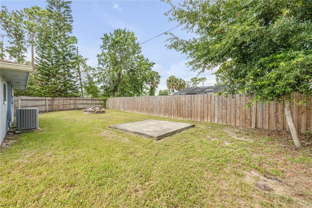 3132 Pine Tree Drive Edgewater, FL 32141 - Photo 31 of 32 a view of a backyard with tree s